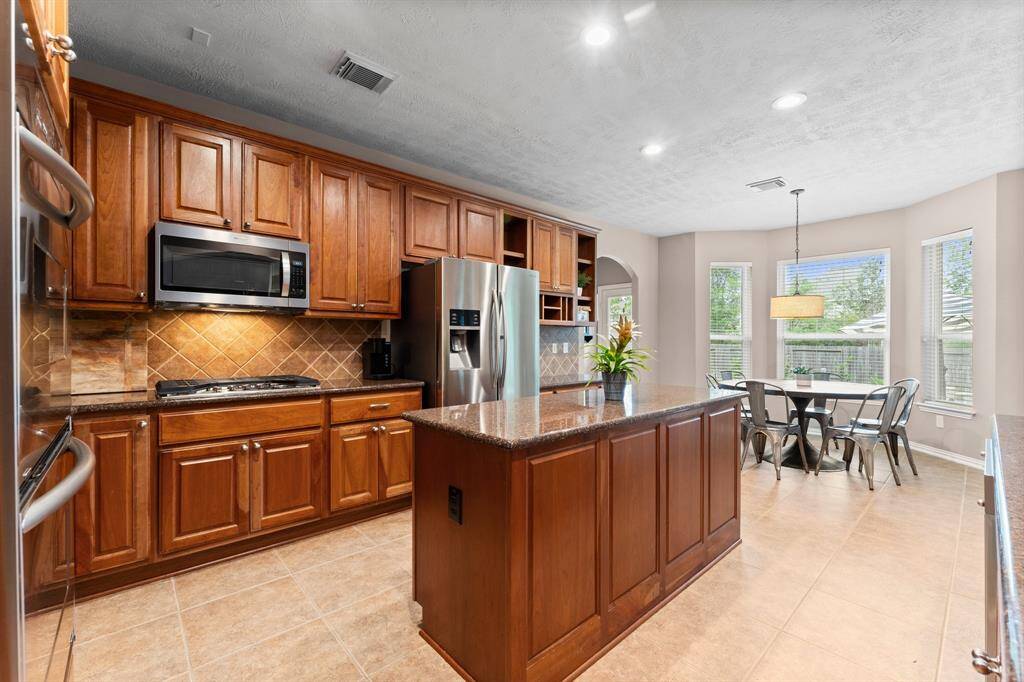 This versatile island is the centerpiece of the kitchen, offering extra cabinetry for organization and ample prep space for the busy chef in the family. Click on the movie reel icon, or visit our on-line documents for a QR Code to see our walk-through video tour of this beautiful Kitchen and Breakfast area!