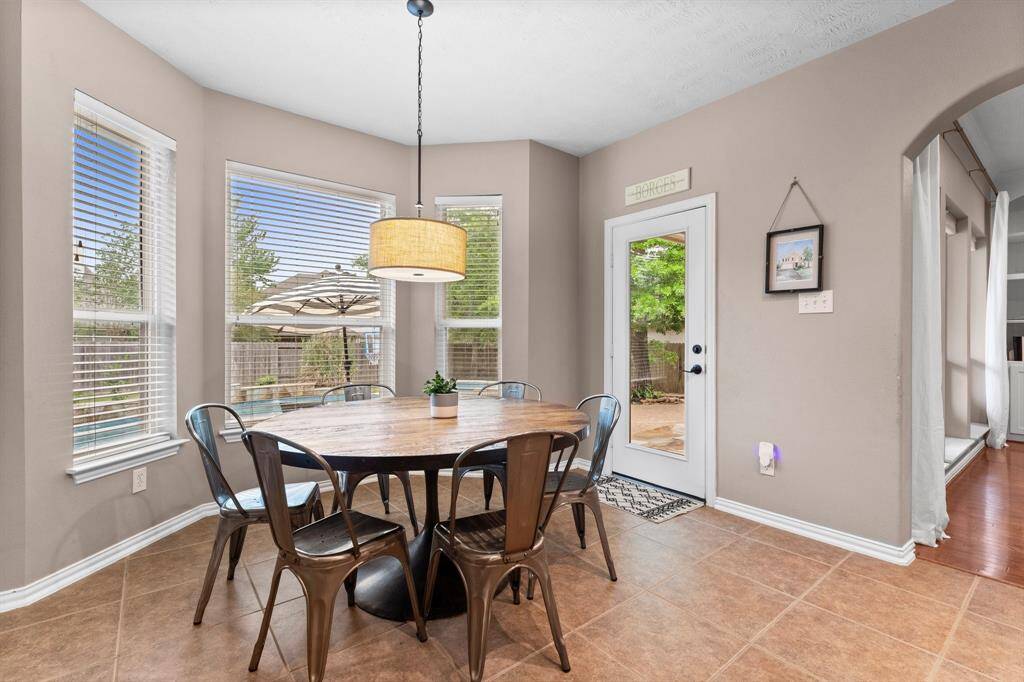 Panoramic views from this roomy breakfast nook! This large space is adjacent to the kitchen and is lined in windows that give an awesome view of the backyard. The backyard, pool, and covered porch are easily from this area to make outdoor entertaining a breeze!
