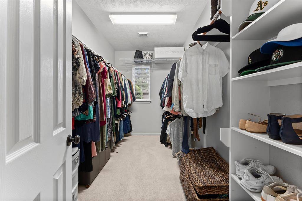 There’s no need to compromise on space with the huge walk-in closet in the Owner’s Suite, featuring built-in shelving, ample hanging space, and a window for natural light — offering the perfect blend of function and elegance. Thoughtfully designed to keep everything organized and beautifully displayed, this closet is a dream for anyone who values space, style, and convenience.
