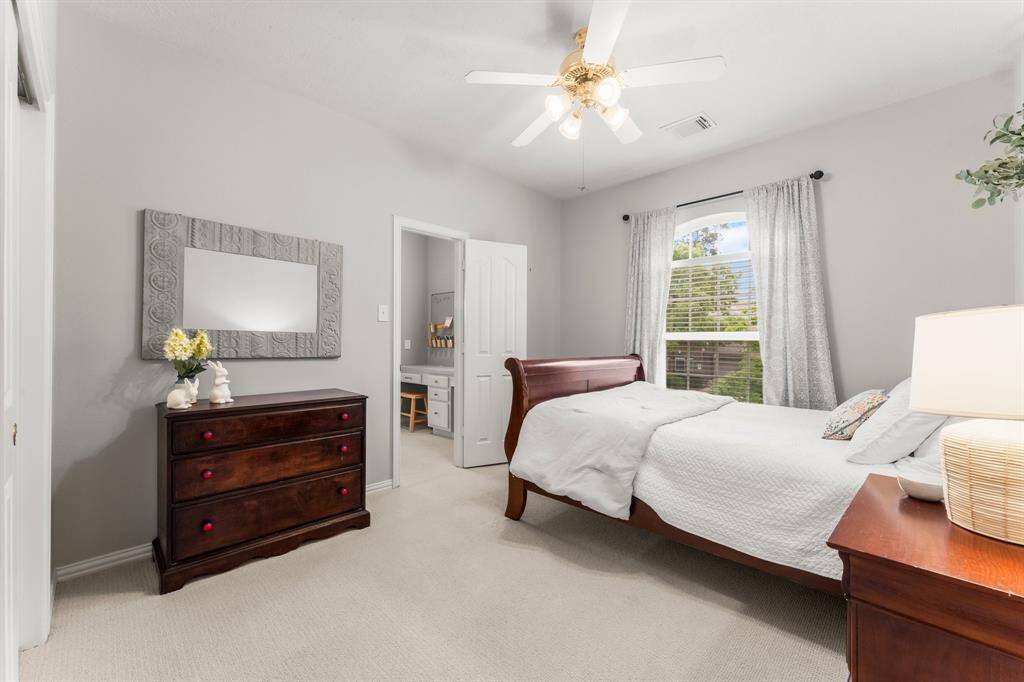 Another secondary bedroom offers lush carpeting, large wall closet, sunny arched window, and lighted ceiling fan. It has hallway access to a full bath shared with Bedroom 5 and also has direct access to the study/gaming  desk area shared with Bedroom 3.