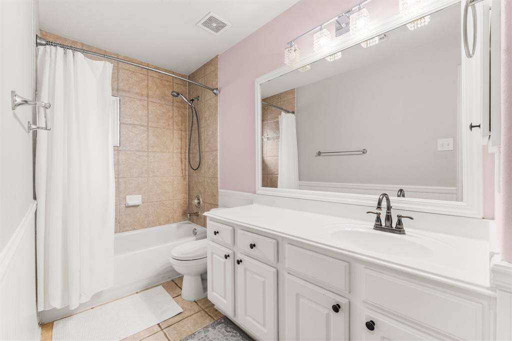 This full bath services the fourth and fifth secondary bedrooms and any game room visitors. It features tile flooring, single sink with extended counter top and integrated sink, medicine cabinet, linen closet, toilet, and tiled shower/tub combo.