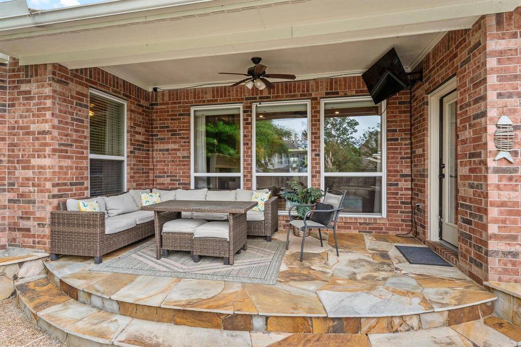 This beautifully designed covered patio is the perfect spot to unwind — whether enjoying a glass of wine, watching the kids play in the pool, or cheering  your favorite team on your outdoor TV. It features rustic flagstone flooring, hookup for your outdoor TV, and a lighted ceiling fan. An adjacent open patio offers additional space for dining and entertaining under the stars. Click on the movie reel icon, or visit our on-line documents for a QR Code to see our walk-through video tour!