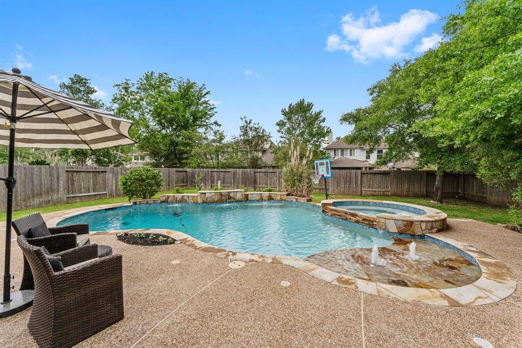 Just what the doctor ordered for perfect spring afternoons and endless summer fun! This stunning pool features three stone waterfalls, a baja shelf with soothing bubblers, large spa, and plenty of deck space for lounging. Towering trees provide privacy, creating a true backyard retreat.