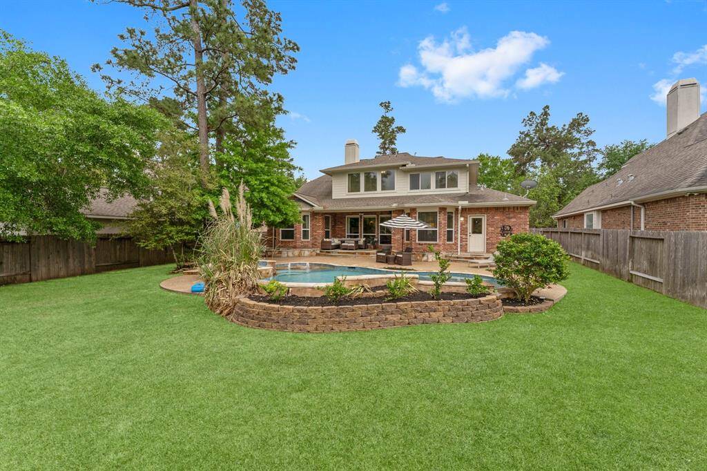 Still so much yard--lush green grass for the play yard, dog house or picnic table! Front and back irrigation system for easy lawn maintenance.