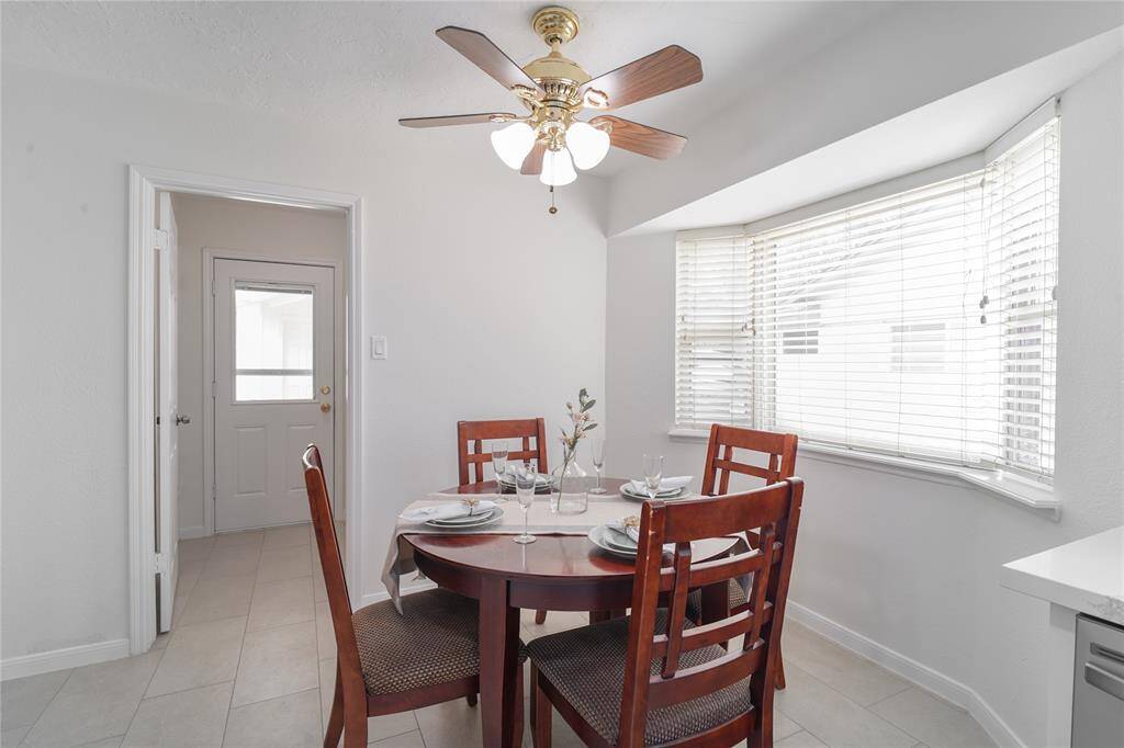 Renovated kitchen and breakfast nook. The Kitchen features soft-close hardwood cabinets all the way to the ceiling with quartz countertops and modern subway style backsplash. New tiles and new stainless steel appliances.