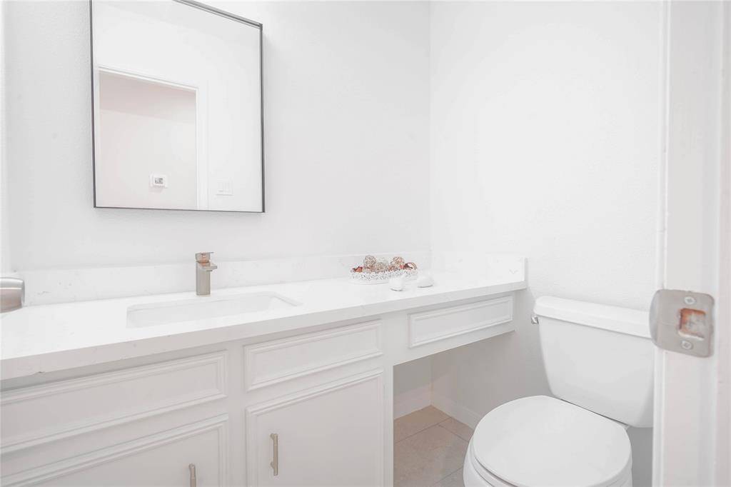 Renovated power room. Quartz countertop with modern fixtures.