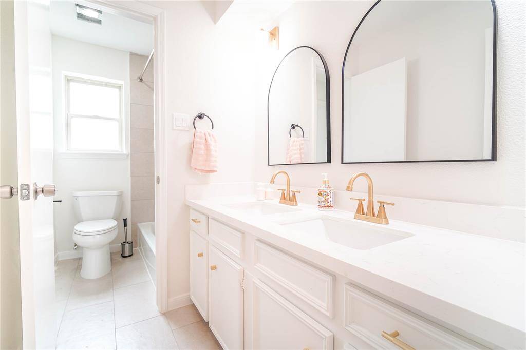 Renovated main bathroom with double sinks.