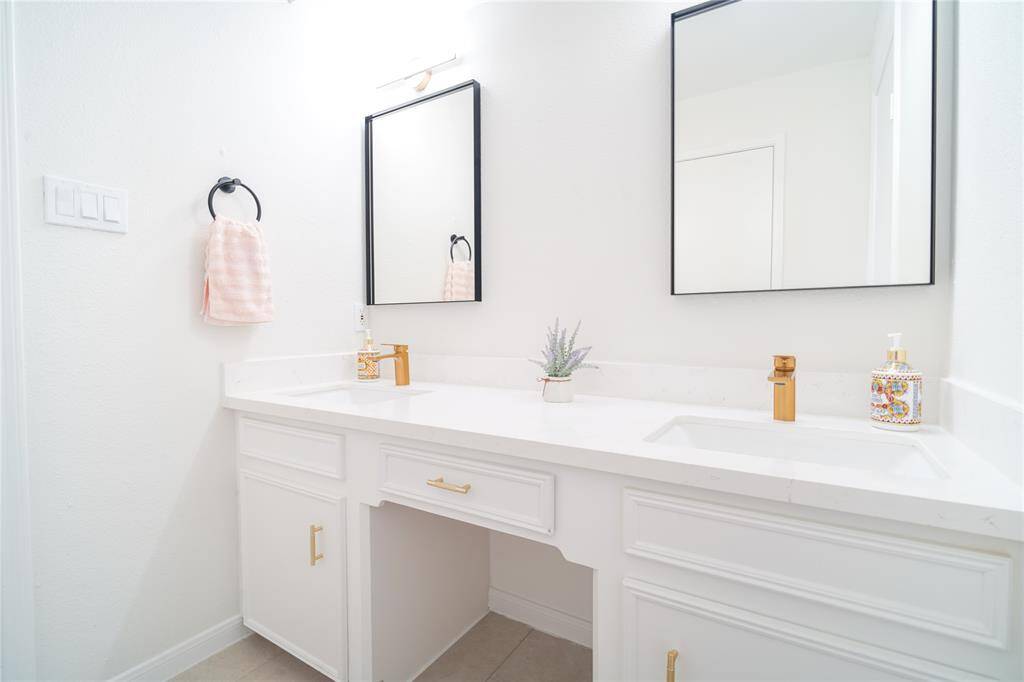 Primary bath with double sinks and modern fixtures.