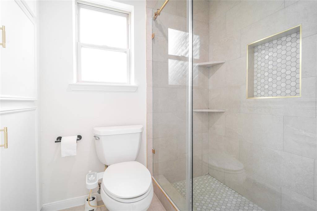 Primary bathroom with newly renovated standing shower.