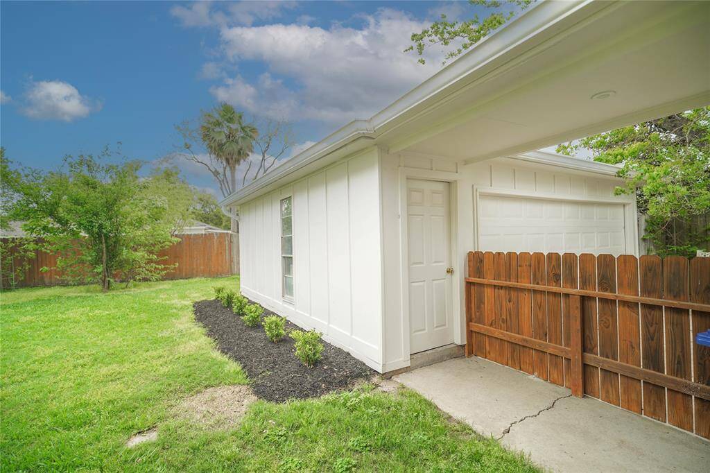Backyard view looking at the garage.