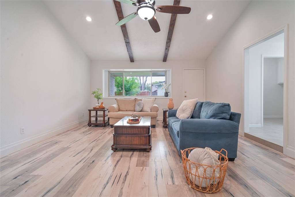 The open living area features a vaulted ceiling with exposed beams.