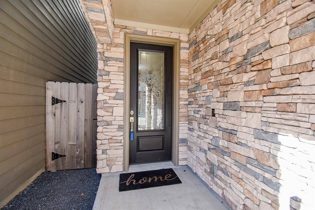 Stylish stone facade welcomes you into a covered porch.