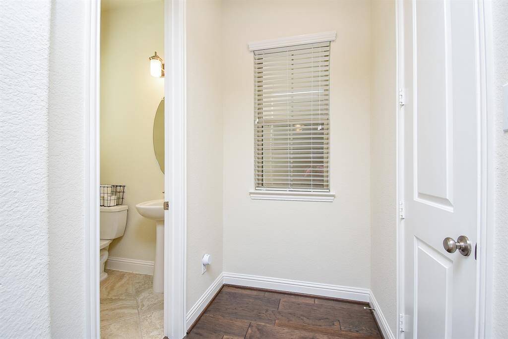 Off main living area is a powder room and storage closet.