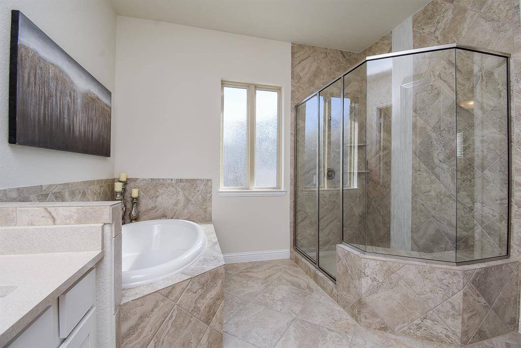 Large primary bathroom features double vanities, huge shower and soaking tub.