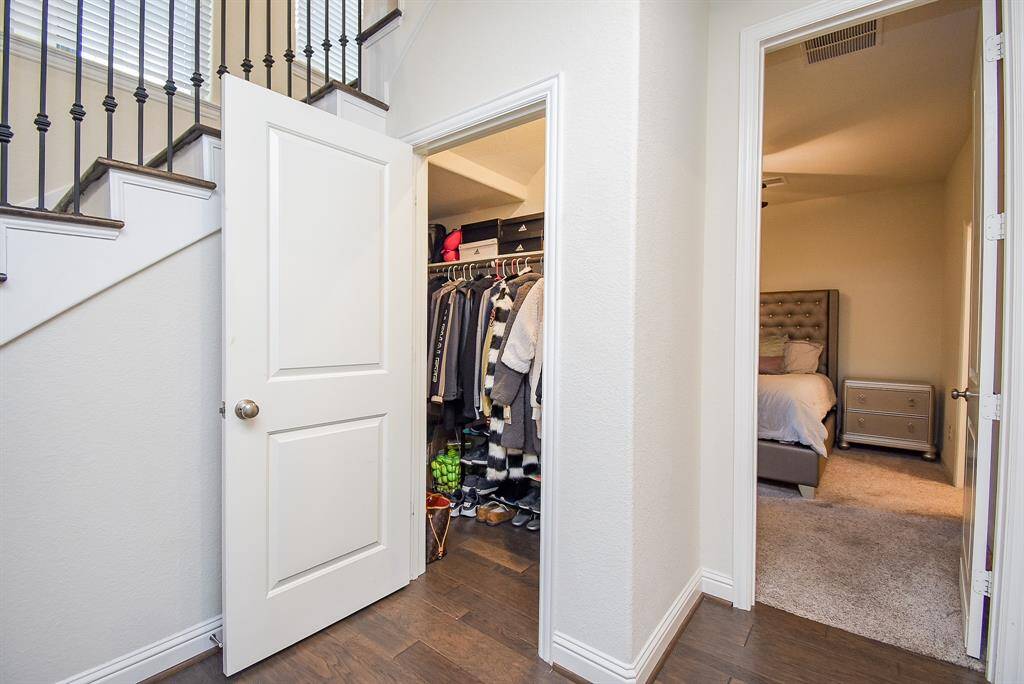 Another downstairs closet and view into downstairs guest bedroom.