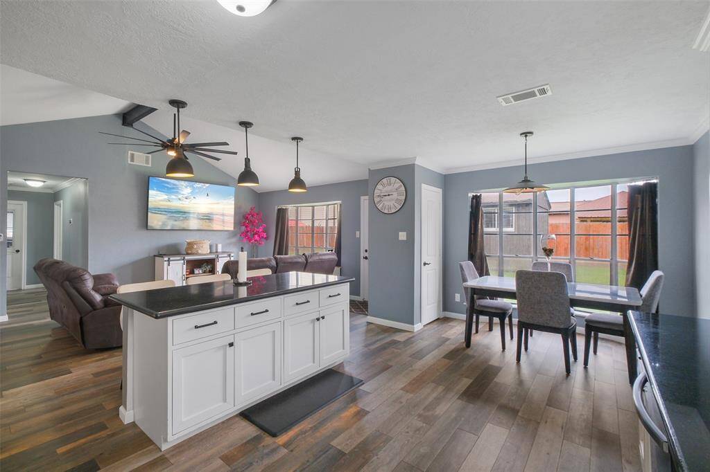Bright dining area with large windows, open flow to kitchen and living—perfect for entertaining!