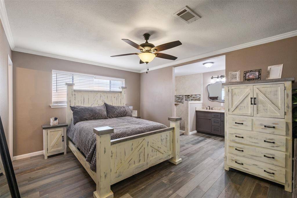 Spacious primary suite with lots of charm, ensuite bath, and beautiful wood-look flooring