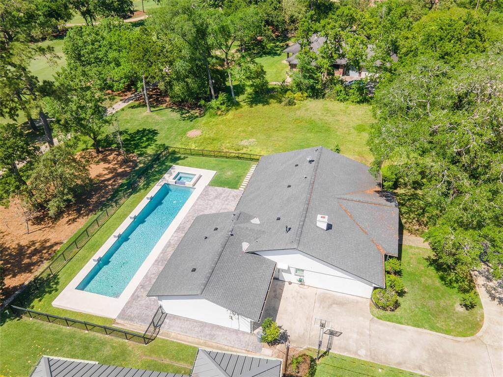 Aerial view shows ample parking and green space as well as proximity to the golf course.