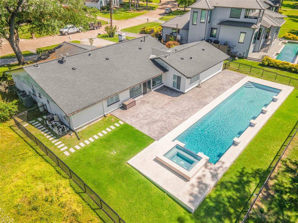 Backyard oasis features custom built 100k lab pool and adjoining spa.