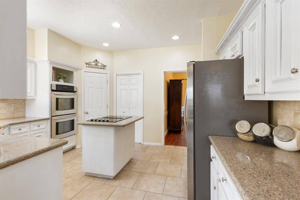 The generously sized pantry and the entry to the laundry room are conveniently located behind the two doors pictured.