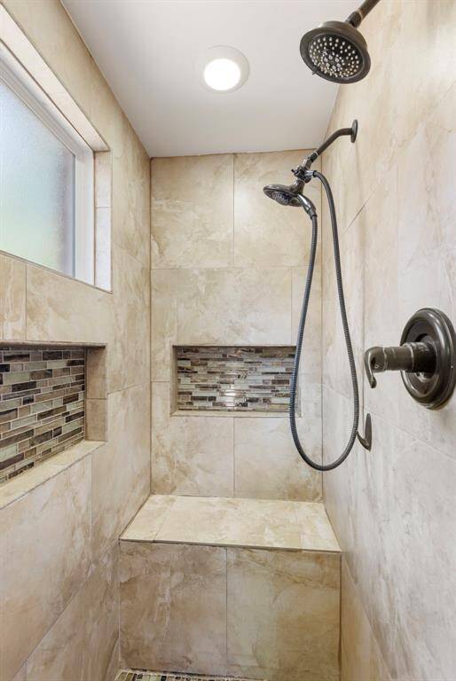 The large walk-in shower features dual shower heads for a relaxing shower experience.