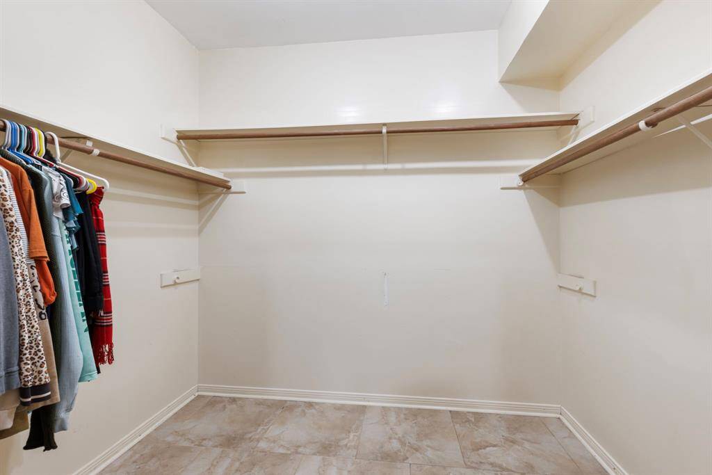 This primary closet is huge, providing all the space you need for your wardrobe!