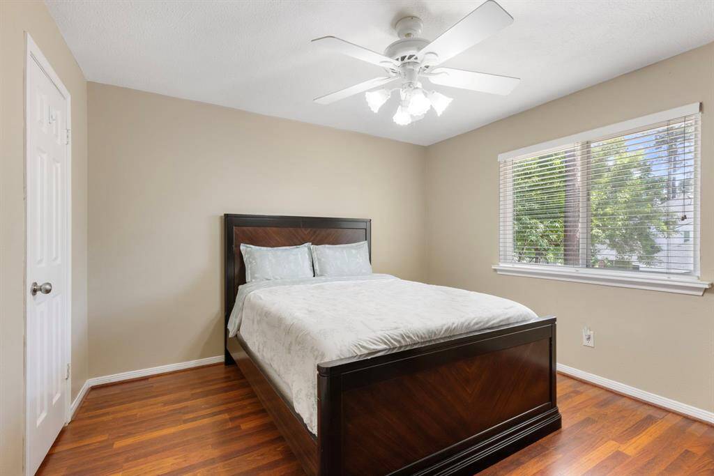 Bright secondary bedroom upstairs with plenty of natural light and ample closet space.
