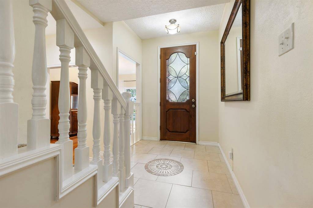 A view of the beautiful front door & all the natural light it lets in.