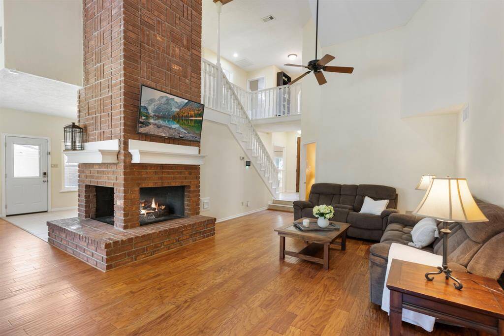 The double-sided brick fireplace is a true showstopper, adding striking character and warmth to the room. It effortlessly serves as the centerpiece, drawing the eye and elevating the entire space!
