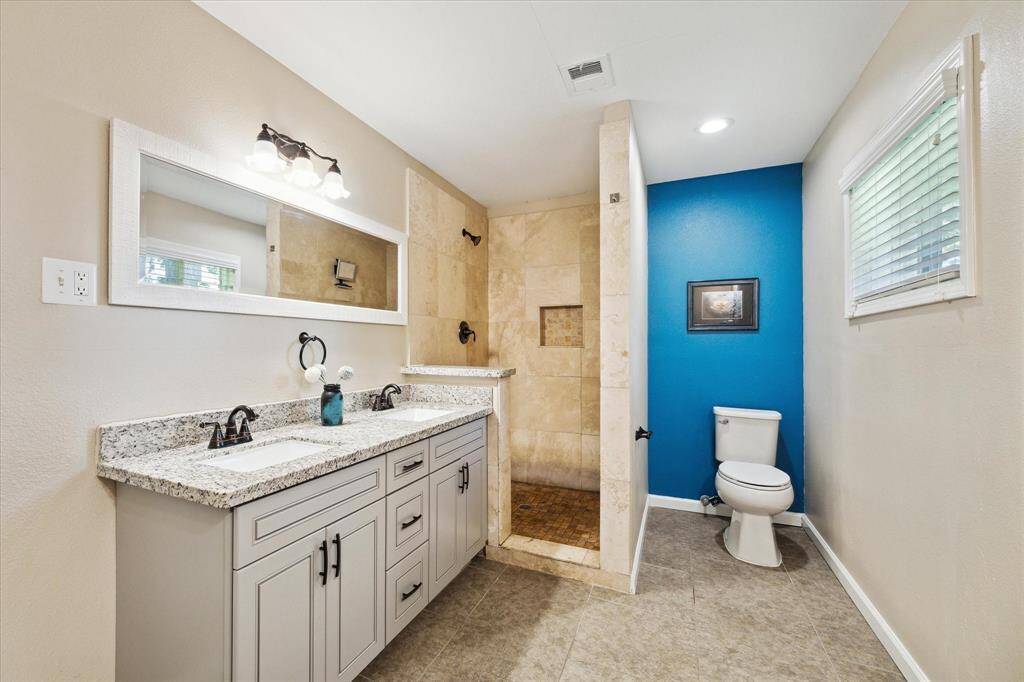 Beautifully updated primary bath provides dual sinks, walk in shower and a ton of extra space that could be used for a separate vanity, storage cabinet, sitting area, you name it!