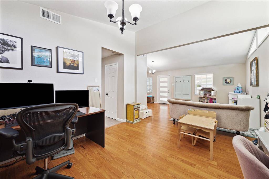 Formal dining room currently being used as a home office - includes laminate wood flooring.