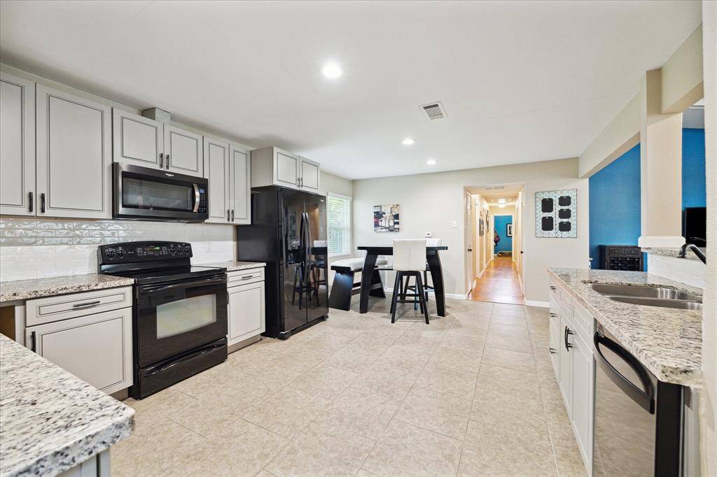 Not to mention, the kitchen is a great size! Could accommodate a separate island for added storage and counter space, if needed.