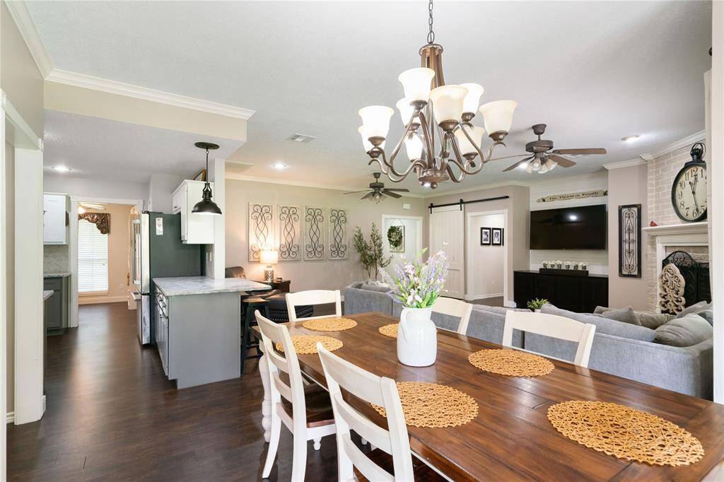 Dining area located just off the living room and kitchen, offering a functional layout for everyday meals or entertaining. Overhead lighting and open sightlines contribute to the home’s connected feel.