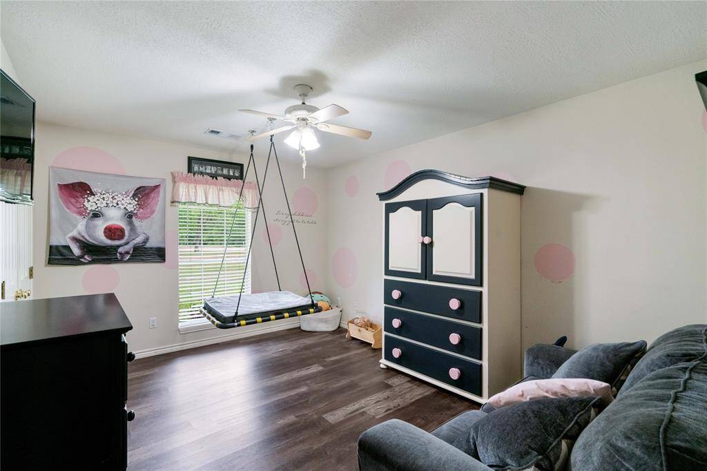 This versatile bedroom includes a ceiling fan, large window for natural light, and wood-style flooring. Currently used as a child’s room, it offers flexibility for a playroom, guest space, or home office.This versatile bedroom includes a ceiling fan, large window for natural light, and durable wood-style flooring. Currently used as a child’s room, it offers flexibility for a playroom, guest space, or home office.