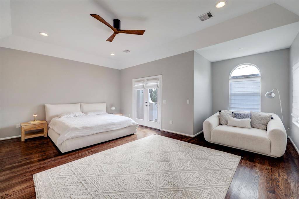 Huge primary bedroom with private balcony and tons of natural light.