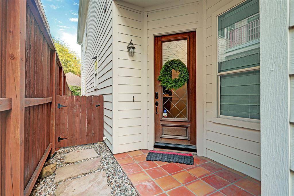 Front door is located through a gated front entrance.