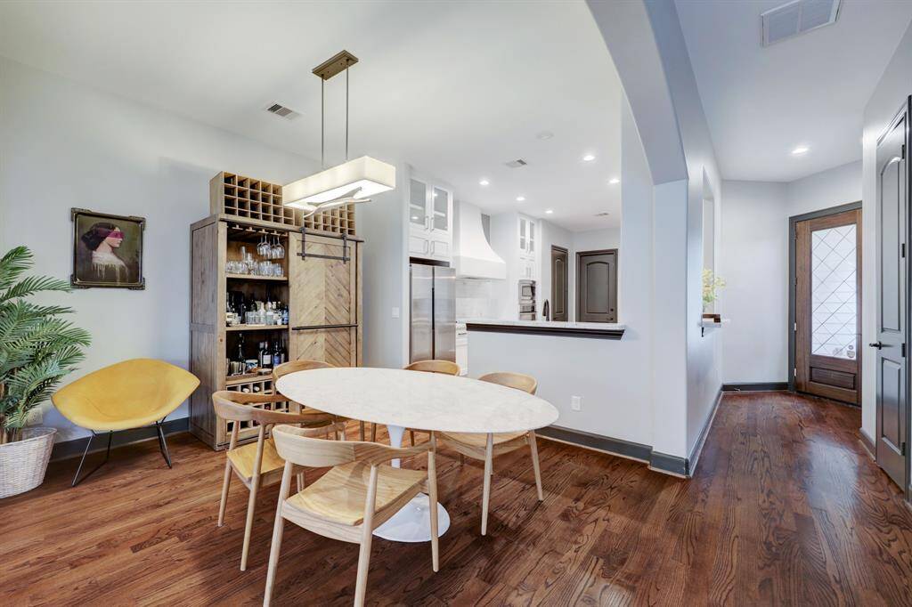 View of the front door, dining room and kitchen.