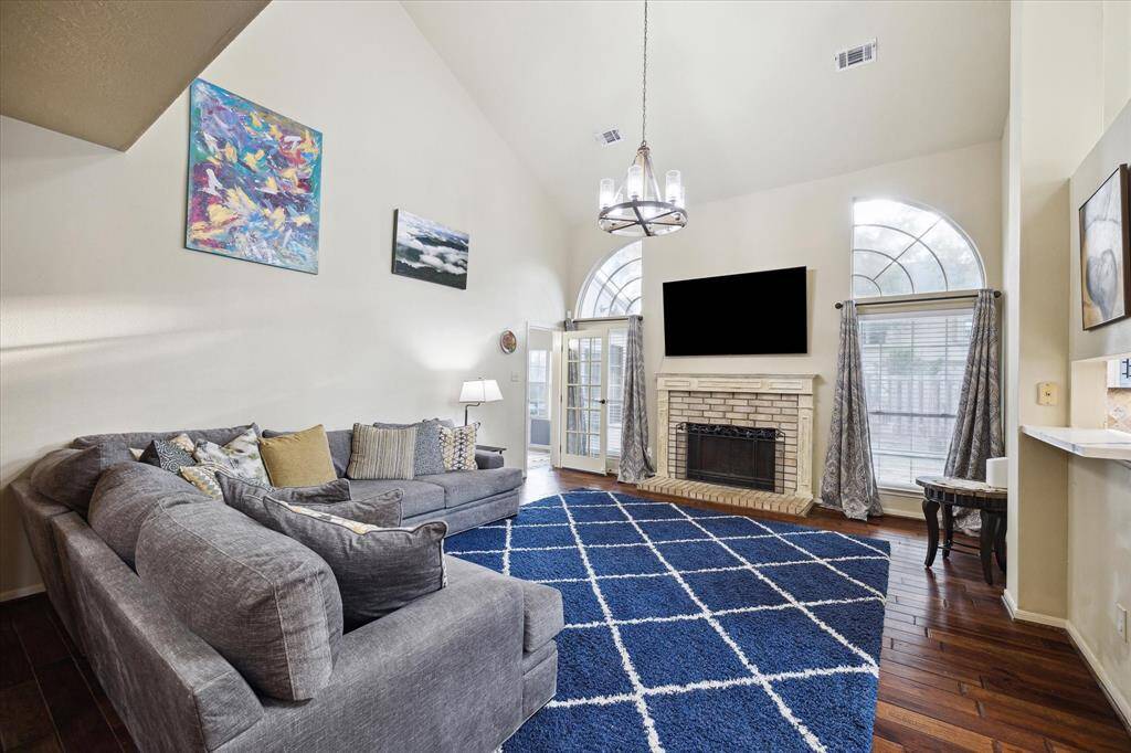 A peak into the air conditioned sun room from the beautiful den, including a gaslog fireplace.