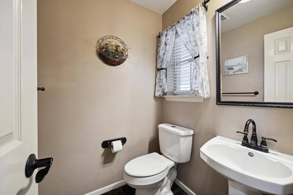 The downstairs poweder room offers comfort and convenience.