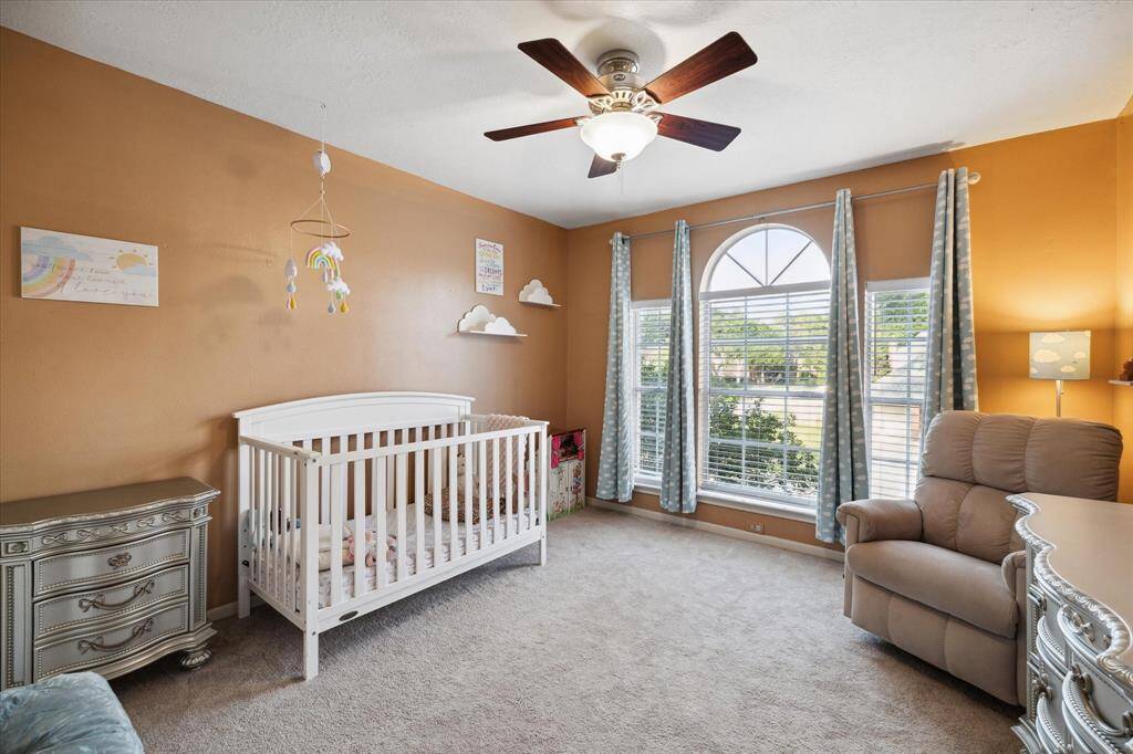 Guest bedroom number three is also quite large with natural light and ceiling fan. That's four bedrooms so far.