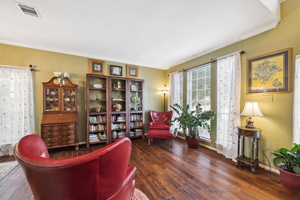 As you enter to the right is your formal living area, which is wide open to the formal dining, making this a massive flexbile space for any of your needs.
