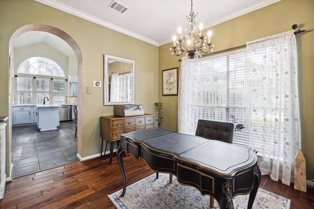 The formal dining area, currently being used for a 2nd office area Notice the crown molding and absolutely gorgeous wood flooring, looking into your stunner of a kitchen.