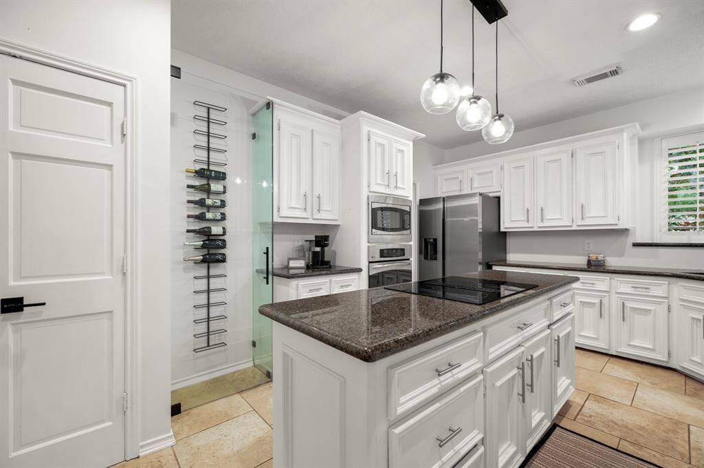 This close-up offers a better look at the glass-enclosed wine storage, adding a touch of elegance and functionality to the kitchen. It's the perfect spot to showcase your wine collection while keeping it easily accessible.