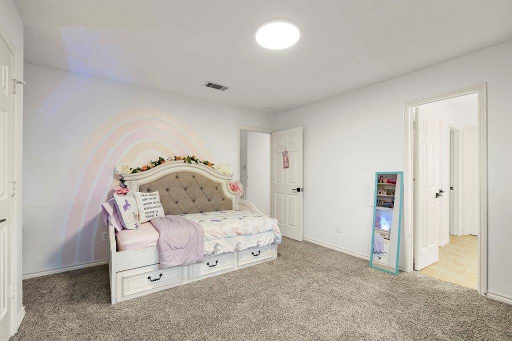 This view of the bedroom shows the connecting bathroom, providing easy access from the room. The layout offers added convenience, making it a perfect setup for privacy and comfort.