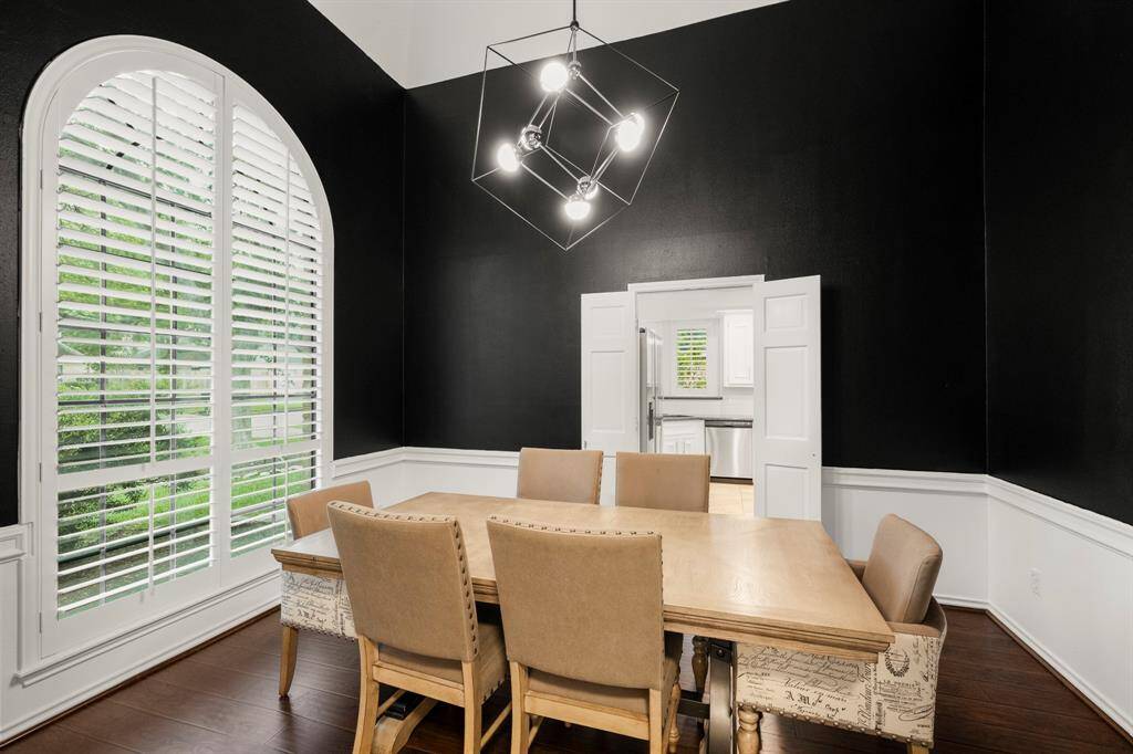 Another view of the formal dining room, where double doors on the far wall open into the spacious kitchen. This layout allows for easy flow between spaces, ideal for entertaining and hosting guests.