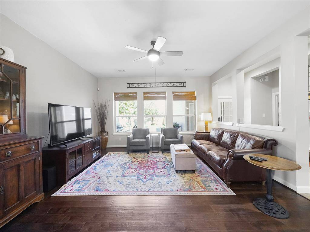 Rich wood flooring adds warmth and character to the space, creating a cozy and inviting atmosphere.