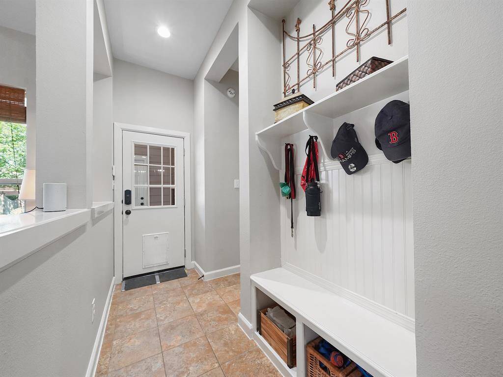 A thoughtfully designed hallway leading to the backdoor features a built-in storage unit, providing a convenient space to store shoes, bags, and other essentials, keeping your home clutter-free and organized.