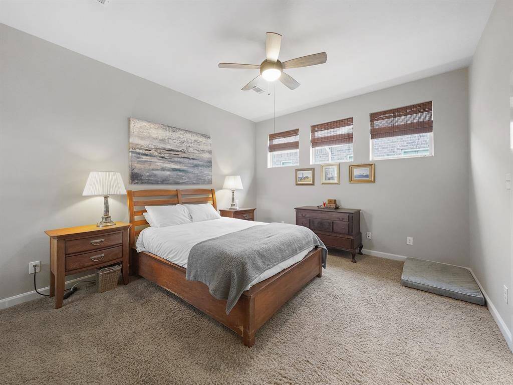 Ample windows flood the room with natural light, creating a bright and airy ambiance. The spacious layout provides plenty of room for a king-size bed and a comfortable seating area.