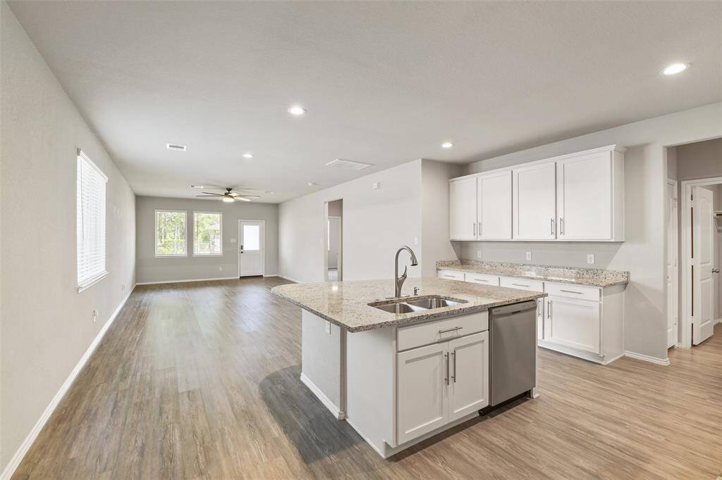Wide open kitchen layout with large island, gas range, and plenty of cabinets for storage.