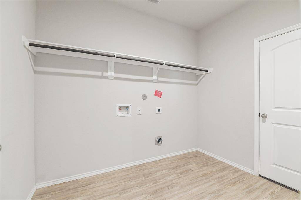 laundry room located between 2 car garage and kitchen